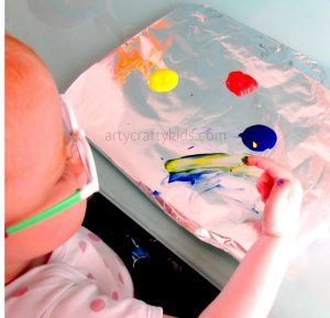 Arty Crafty Kids - Art - Toddler fingerpainting on tinfoil