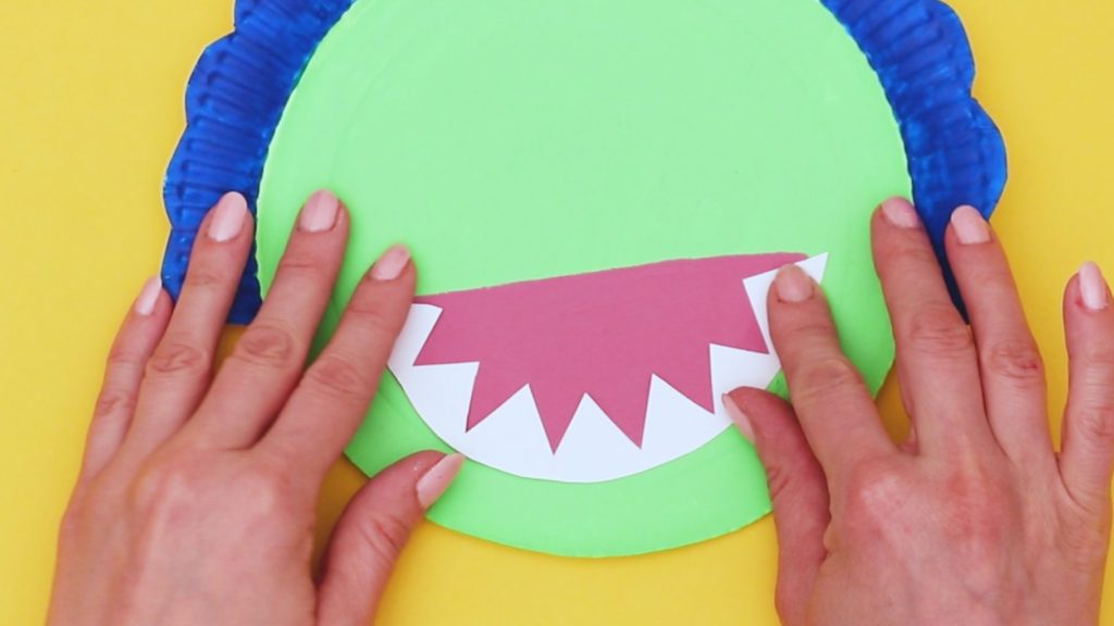 Image showing a toothy grin being stuck to the pink mouth.