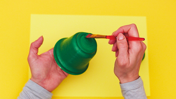 Paint the yoghurt pot green to create a frogs body.