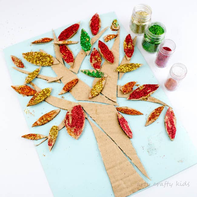 Arty Crafty Kids | Craft | Cardboard Autumn Glitter Tree | A colourful Autumn tree craft using cut up recycled cardboard to assemble a tree. Great fine motor activity for young children!
