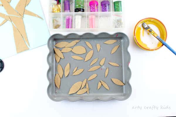 Arty Crafty Kids | Craft | Cardboard Autumn Glitter Tree | A colourful Autumn tree craft using cut up recycled cardboard to assemble a tree. Great fine motor activity for young children!