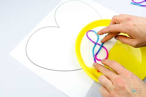 Arty Crafty Kids | Art Ideas for Kids | Yarn Squiggle Heart Art | A fun process art idea for kids, using yarn and watercolour paints to create a cute heart. A simple and fun art project for Valentine's Day! #Valentinesday #artforkids #easyartforkids