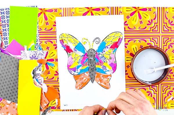 Arty Crafty Kids | Art | Butterly Paper Collage - A simple activity using torn scrap paper to create a colourful, textured butterfly. A wonderful craft for kids! #artycraftykids #recycledcraft #easykidscraft #craftsforkids #kidsart #artideasforkids #easykidsactivities