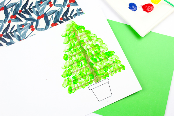 Arty Crafty Kids | Fingerprint Christmas Tree Card - Using the template as a card, kids can add a personal touch to their Christmas Cards by adding their fingerprints to form a Christmas Tree. A simple, beautiful Christmas card idea that kids will love creating #christmascrafts #christmas #papercrafts #kidscrafts #template #printables
