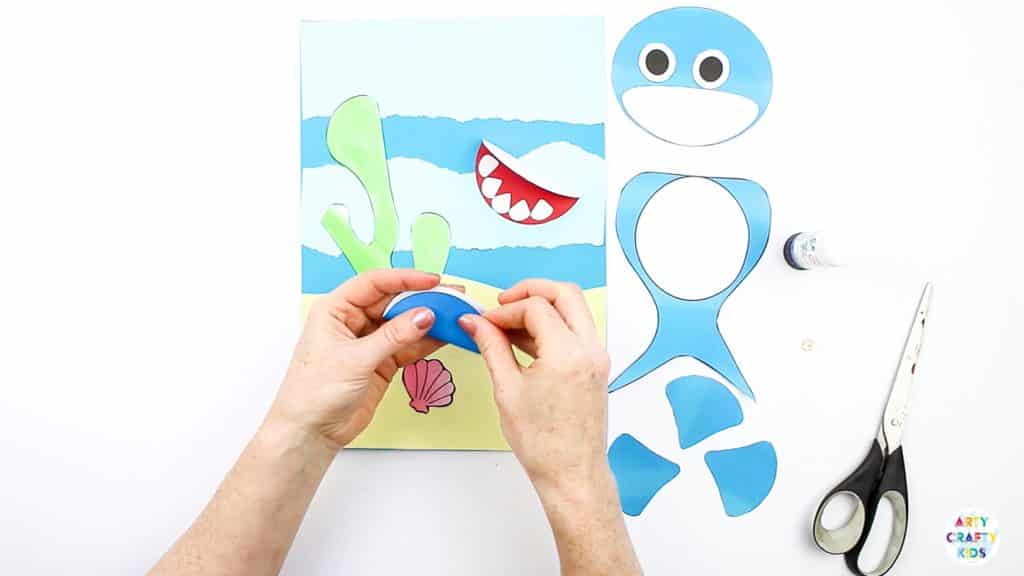 An easy Swimming Baby Shark Craft for kids to make. A great printable shark craft for  Summer and shark week. #artycraftykids #sharkweek #craftsforkids