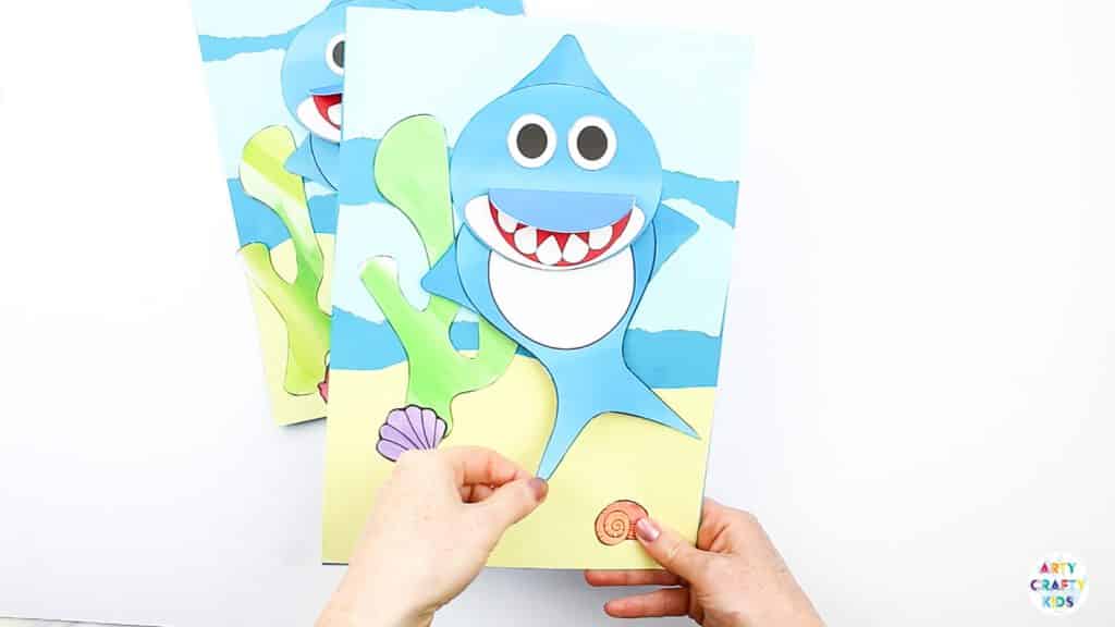 An easy Swimming Baby Shark Craft for kids to make. A great printable shark craft for  Summer and shark week. #artycraftykids #sharkweek #craftsforkids