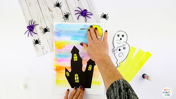 Arty Crafty Kids | Easy Bobble Ghost Halloween Craft for Kids. These playful ghosts will bounce and bobble above their haunted house, creating a fun and engaging paper craft kids will love!