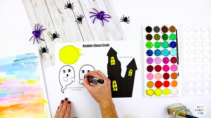 Arty Crafty Kids | Easy Bobble Ghost Halloween Craft for Kids. These playful ghosts will bounce and bobble above their haunted house, creating a fun and engaging paper craft kids will love!