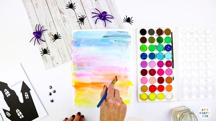 Arty Crafty Kids | Easy Bobble Ghost Halloween Craft for Kids. These playful ghosts will bounce and bobble above their haunted house, creating a fun and engaging paper craft kids will love!