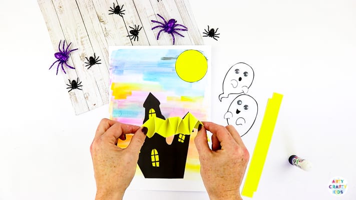 Arty Crafty Kids | Easy Bobble Ghost Halloween Craft for Kids. These playful ghosts will bounce and bobble above their haunted house, creating a fun and engaging paper craft kids will love!