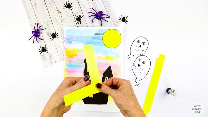 Arty Crafty Kids | Easy Bobble Ghost Halloween Craft for Kids. These playful ghosts will bounce and bobble above their haunted house, creating a fun and engaging paper craft kids will love!