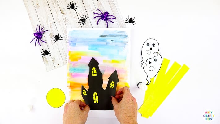 Arty Crafty Kids | Easy Bobble Ghost Halloween Craft for Kids. These playful ghosts will bounce and bobble above their haunted house, creating a fun and engaging paper craft kids will love!