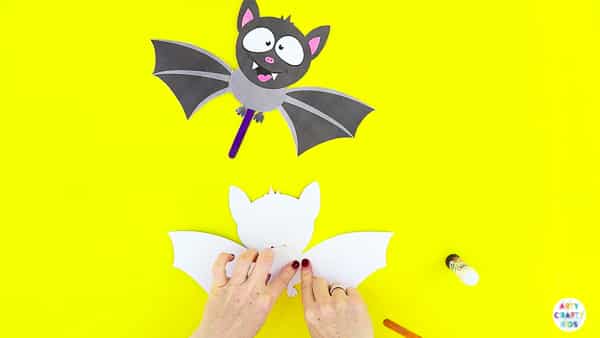 Halloween Crafts for Kids | Glue the wings to the paper toy bat.