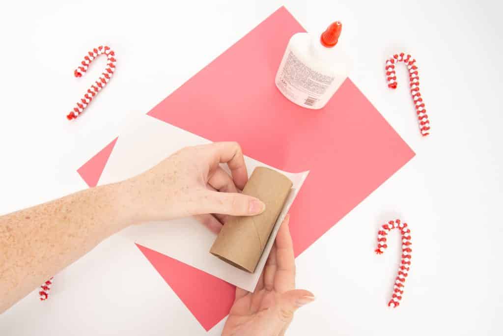 Add white paper around the toilet paper roll craft.