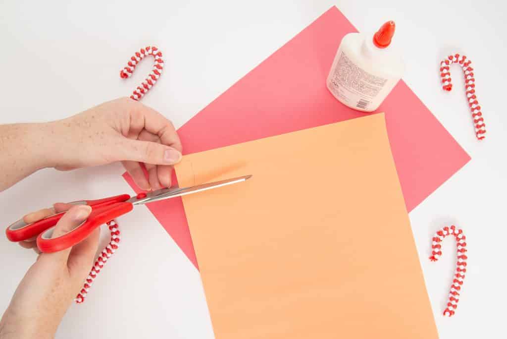 Use orange construction paper to create a nose for the paper roll snowman.