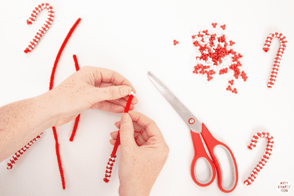 Make Beaded Candy Cane Ornaments with the kids this Christmas. Made with just two materials, kids will love this  simple and fun Christmas craft.