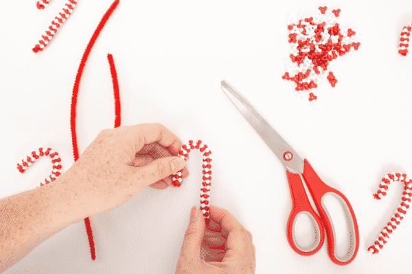 Make Beaded Candy Cane Ornaments with the kids this Christmas. Made with just two materials, kids will love this  simple and fun Christmas craft.