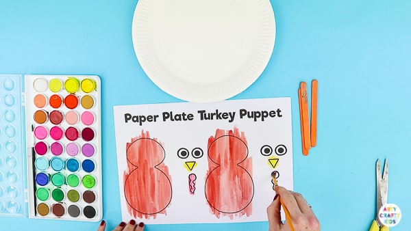 Arty Crafty Kids | Using a printable turkey template to create a turkey puppet.