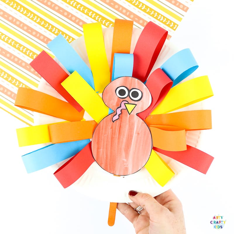 A fun and interactive paper plate turkey craft for kids to make. An easy Thanksgiving craft that kids will love!