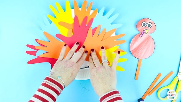 Fill the paper plate turkey with handprints to create feathers.