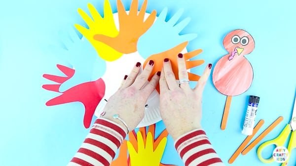 Fill the paper plate turkey with handprints to create feathers.