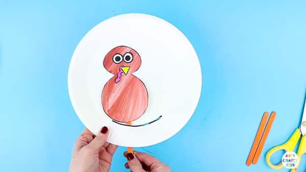 Add the printable turkey puppet to the paper plate.