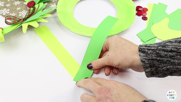 Arty Crafty Kids | Easy Paper Plate Handprint Christmas Wreath for Kids to make.