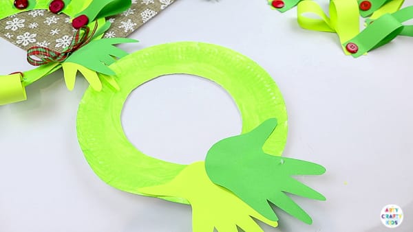 Arty Crafty Kids | Easy Paper Plate Handprint Christmas Wreath for Kids to make.