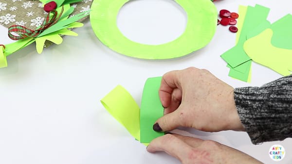 Arty Crafty Kids | Easy Paper Plate Handprint Christmas Wreath for Kids to make.