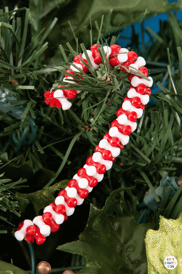 Make Beaded Candy Cane Ornaments with the kids this Christmas. Made with just two materials, kids will love this  simple and fun Christmas craft.