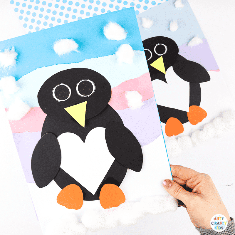 Interactive Paper Penguin Craft - Inspired by Happy Feet. A fun and engaging Winter craft for Kids. With a penguin that moves and dances on the snowy floor, this is a craft that inspires children to play!