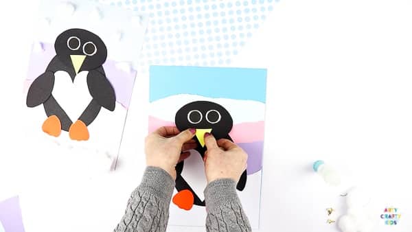 Interactive Paper Penguin Craft - Inspired by Happy Feet. A fun and engaging Winter craft for Kids. With a penguin that moves and dances on the snowy floor, this is a craft that inspires children to play!