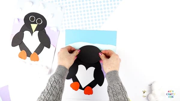 Interactive Paper Penguin Craft - Inspired by Happy Feet. A fun and engaging Winter craft for Kids. With a penguin that moves and dances on the snowy floor, this is a craft that inspires children to play!