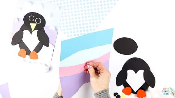 Interactive Paper Penguin Craft - Inspired by Happy Feet. A fun and engaging Winter craft for Kids. With a penguin that moves and dances on the snowy floor, this is a craft that inspires children to play!