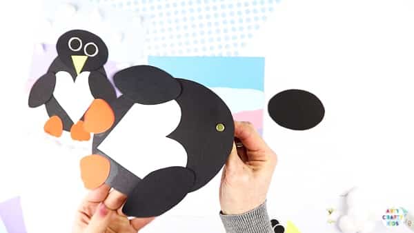 Interactive Paper Penguin Craft - Inspired by Happy Feet. A fun and engaging Winter craft for Kids. With a penguin that moves and dances on the snowy floor, this is a craft that inspires children to play!