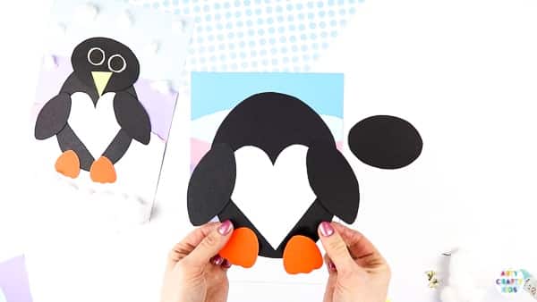 Interactive Paper Penguin Craft - Inspired by Happy Feet. A fun and engaging Winter craft for Kids. With a penguin that moves and dances on the snowy floor, this is a craft that inspires children to play!