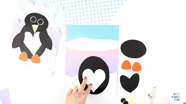 Interactive Paper Penguin Craft - Inspired by Happy Feet. A fun and engaging Winter craft for Kids. With a penguin that moves and dances on the snowy floor, this is a craft that inspires children to play!