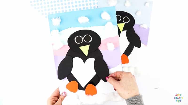 Interactive Paper Penguin Craft - Inspired by Happy Feet. A fun and engaging Winter craft for Kids. With a penguin that moves and dances on the snowy floor, this is a craft that inspires children to play! This craft can be completed with our Printable Penguin Template.