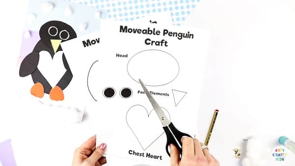 Interactive Paper Penguin Craft - Inspired by Happy Feet. A fun and engaging Winter craft for Kids. With a penguin that moves and dances on the snowy floor, this is a craft that inspires children to play!