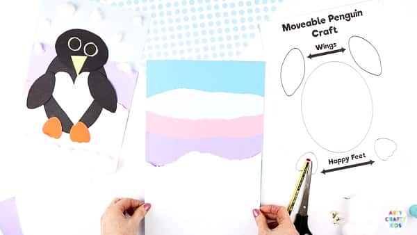 Interactive Paper Penguin Craft - Inspired by Happy Feet. A fun and engaging Winter craft for Kids. With a penguin that moves and dances on the snowy floor, this is a craft that inspires children to play!