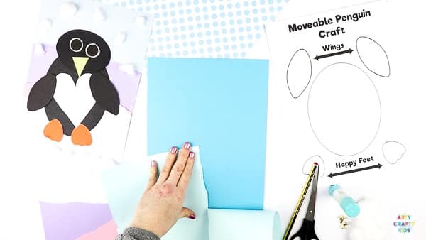 Interactive Paper Penguin Craft - Inspired by Happy Feet. A fun and engaging Winter craft for Kids. With a penguin that moves and dances on the snowy floor, this is a craft that inspires children to play!