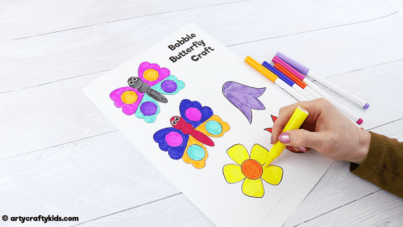 Make a Bobble Butterfly Craft with Spring Flowers with the Kids.  A fun and easy Spring craft that kids will love. The butterfly craft can be completed with our printable butterfly template.