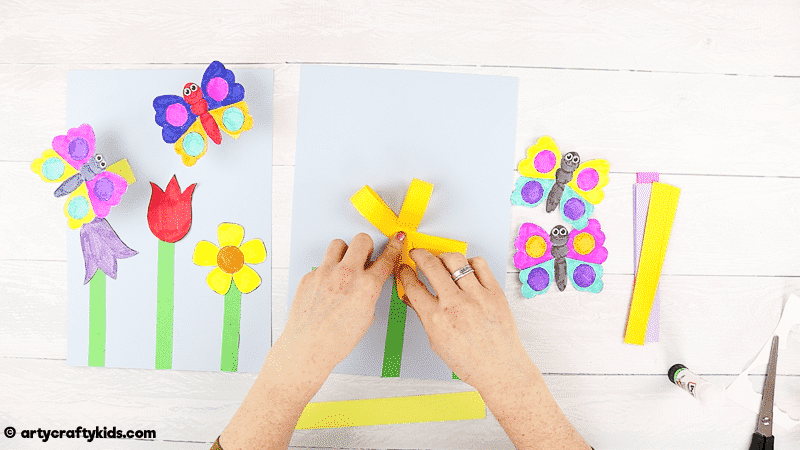 Make a Bobble Butterfly Craft with Spring Flowers with the Kids.  A fun and easy Spring craft that kids will love. The butterfly craft can be completed with our printable butterfly template.