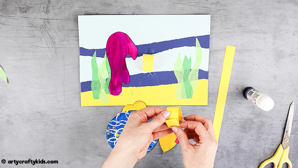 Create three loops using strips of construction paper.