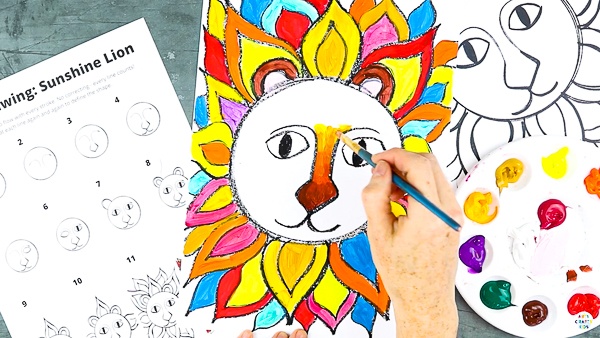 Let's begin painting the lion. Fill the mane with bright fiery colours - red, yellow, orange.