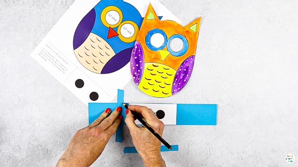 Create two smaller strips to secure behind the eye holes of the owl.