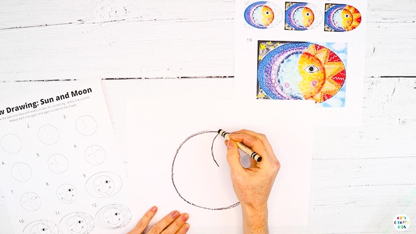 Next, divide the circle to create two distinct faces - sun and moon.