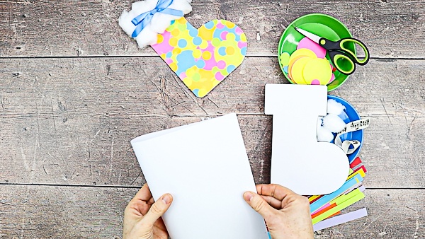 Fold a piece of blank white cardstock in half.