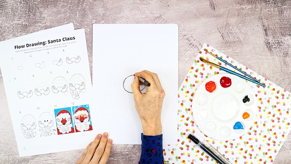 Start by drawing Santa's nose in a central position on the cardstock.