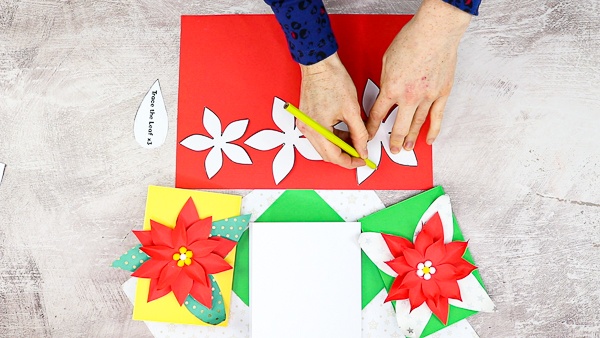 Trace the elements of the poinsettia flower onto red and green paper.